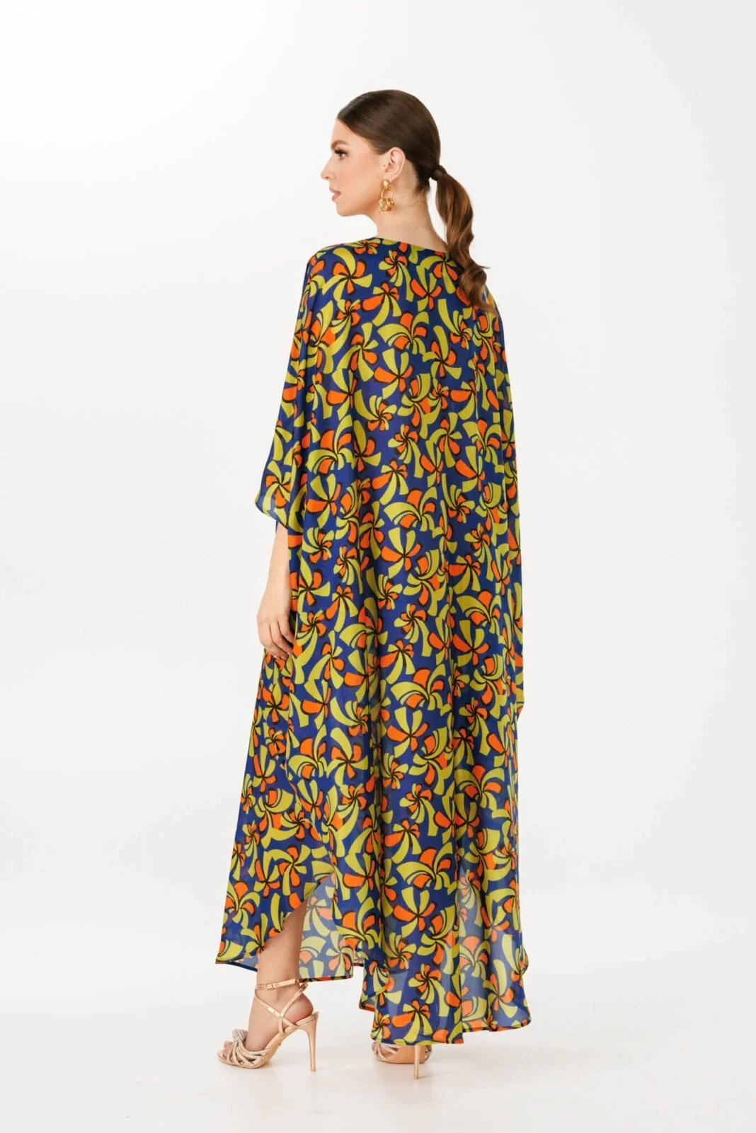 Woman wearing luxurious colorful maxi dress by house of azoiia